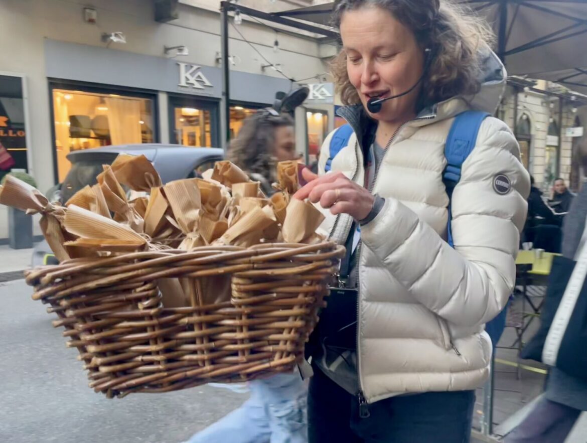 Sarah, la guida di Torino Golosa, con un cestino di grissini della panetteria Perino Vesco a Torino